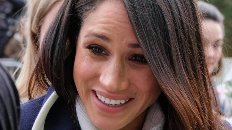 Meghan Markle outdoors crowd smiling