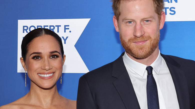 Prince Harry and Meghan Markle event smiling