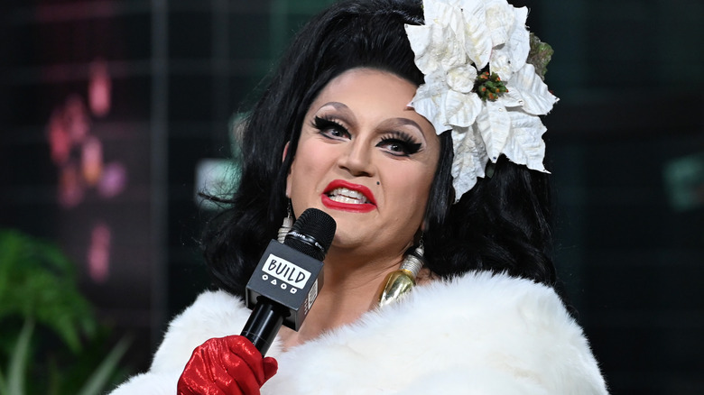 BenDeLaCreme holding microphone