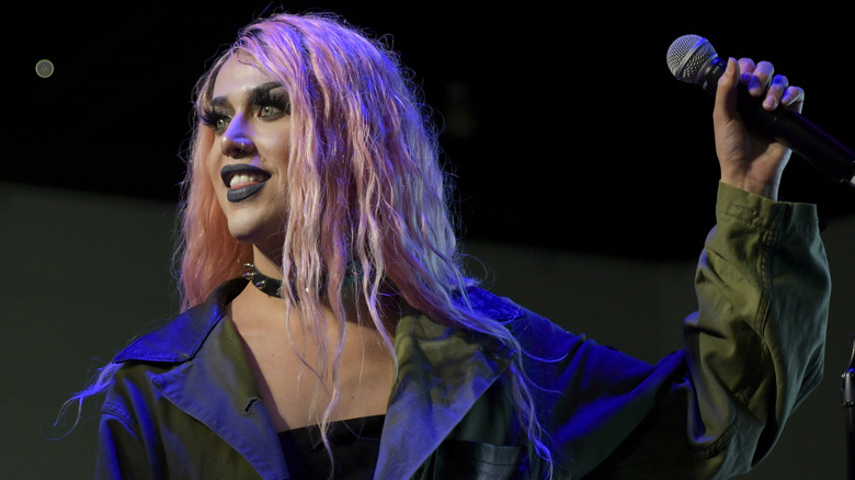 Adore Delano holding microphone