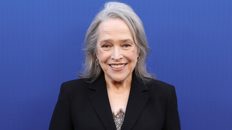 Close up of Kathy Bates smiling in a black jacket