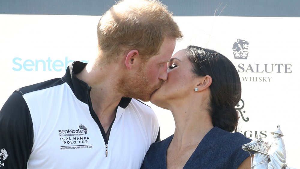 Prince Harry and Meghan Markle sharing an epic royal kiss