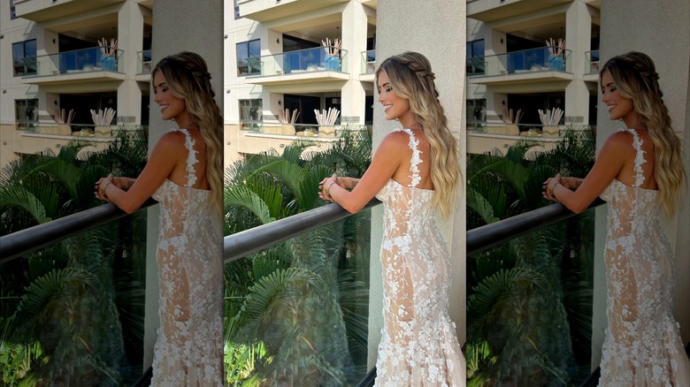 Christina Hall posing in her wedding dress on a balcony