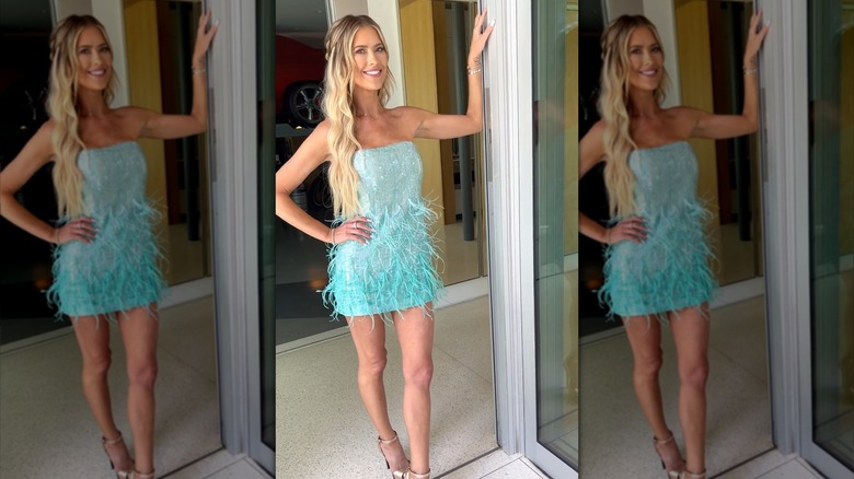 Christina Hall posing in a turquoise mini dress