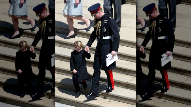 Prince William holding Prince George's hand