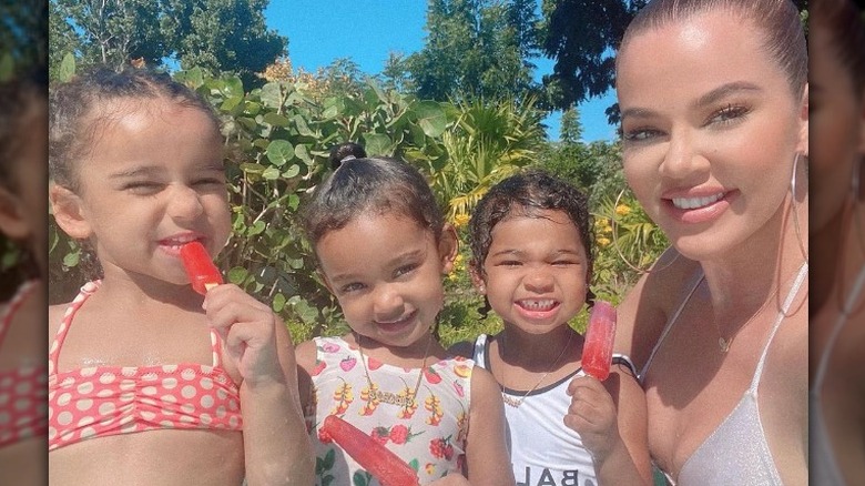 Dream Kardashian, Chicago West, and True Thompson, and Khloe Kardashian smiling