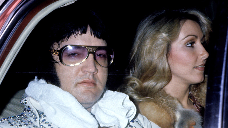 Elvis Presley and Linda Thompson riding in a car