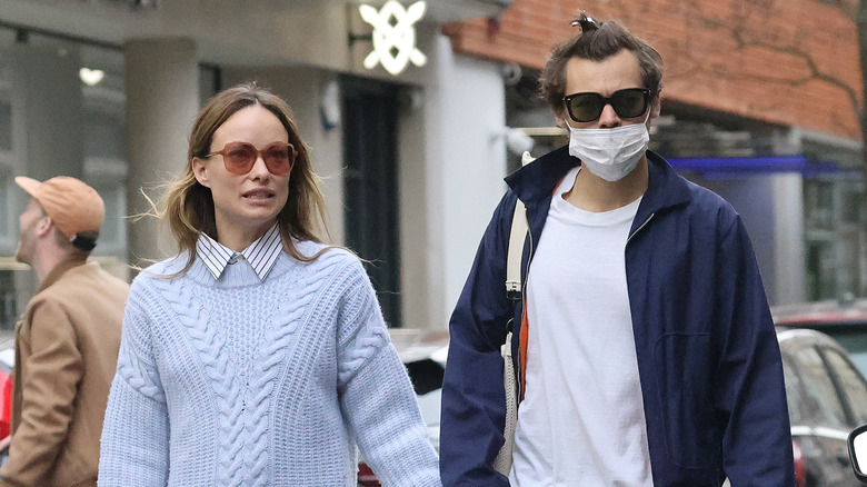 Harry Styles and Olivia Wilde walking around while holding hands