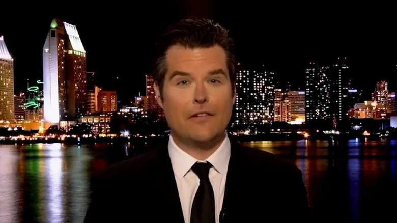 Matt Gaetz hosting during his show with city skyline in background