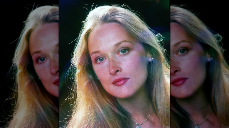 Meryl Streep posing in 1976 with long flowing hair and ruby lips.