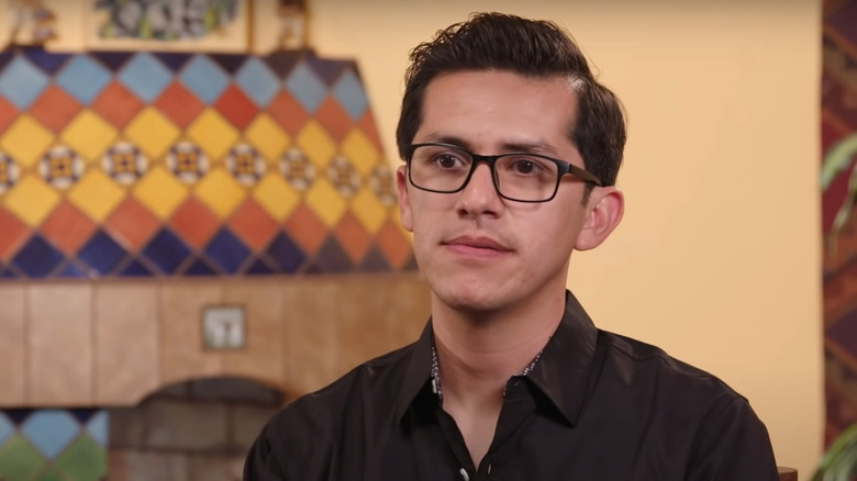 Armando Rubio seated during an interview 