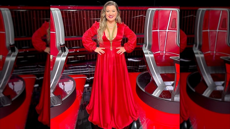 Kelly Clarkson smiling in red dress