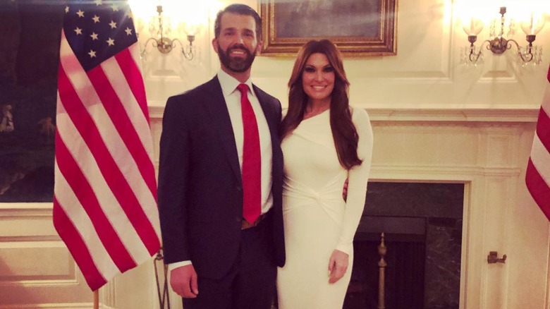 Kimberly Guilfoyle in white dress beside Trump family