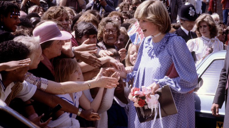 Princess Diana shaking hands with the public