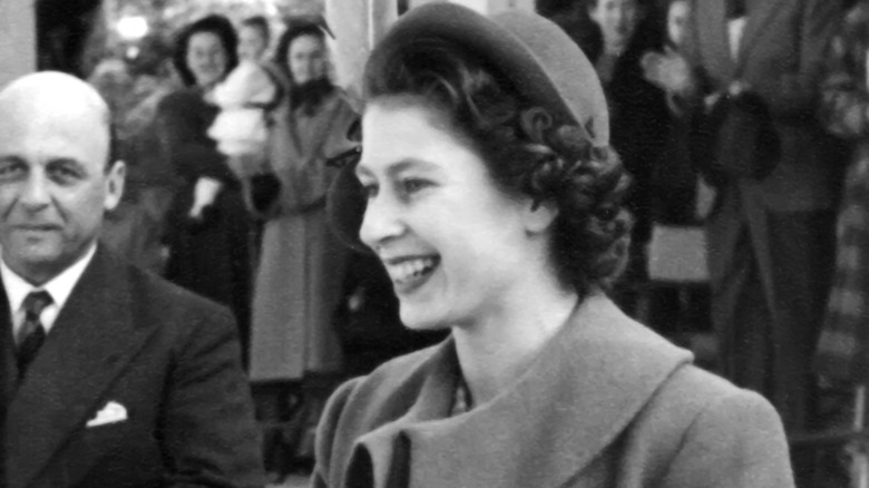 Young Queen Elizabeth II smiling in crowd