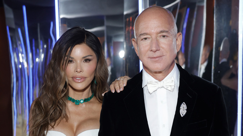 Lauren Sanchez and Jeff Bezos posing for a picture at a party