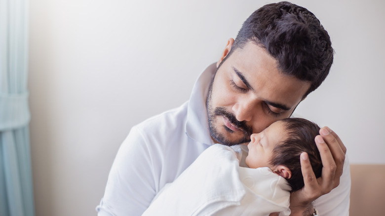 Father holding infant