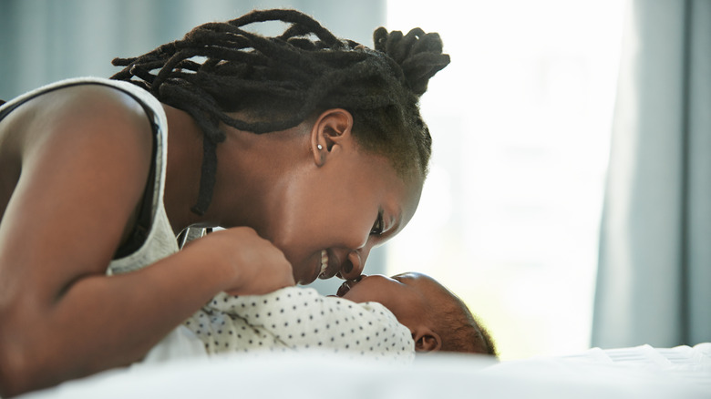 Mother playing with infant