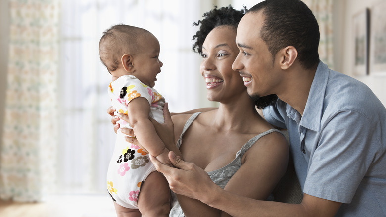 Couple looking at baby