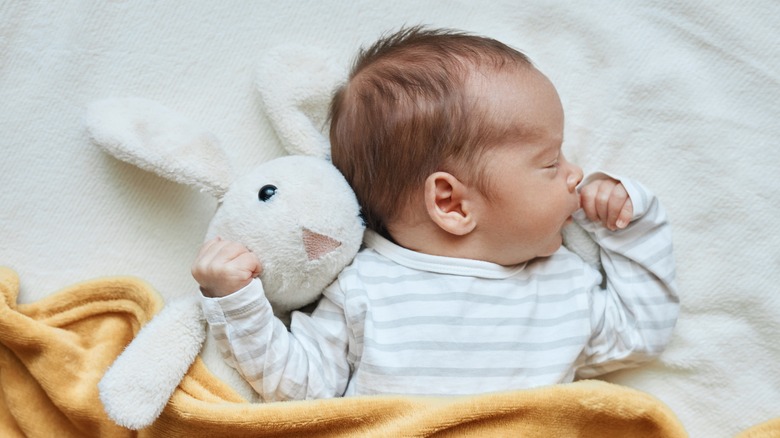 Sleeping baby with a toy rabbit