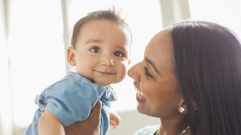 Mother smiling at a baby boy