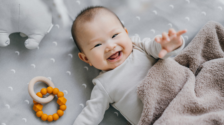 Baby laughing and reaching towards camera