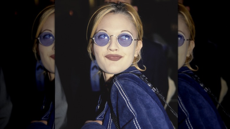 Drew Barrymore in grinning in sunglasses