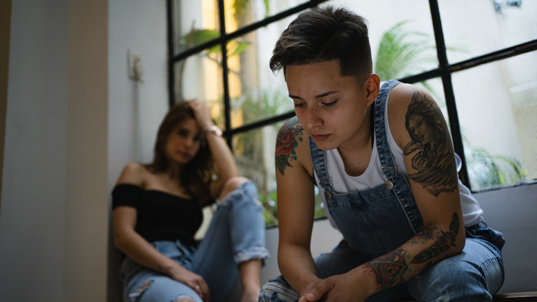 Women looking unhappy sitting away from each other