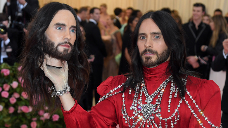 Jared Leto holds up a replica of his head for a photo