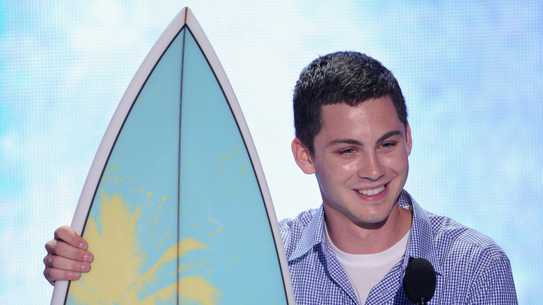 Logan Lerman accepts an award onstage