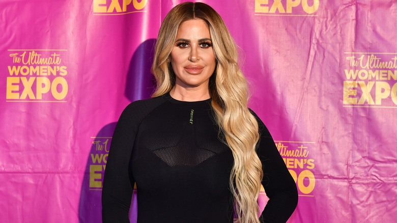 Kim Zolciak-Biermann smiling on step-and-repeat