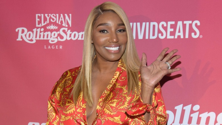 NeNe Leakes waving on step-and-repeat