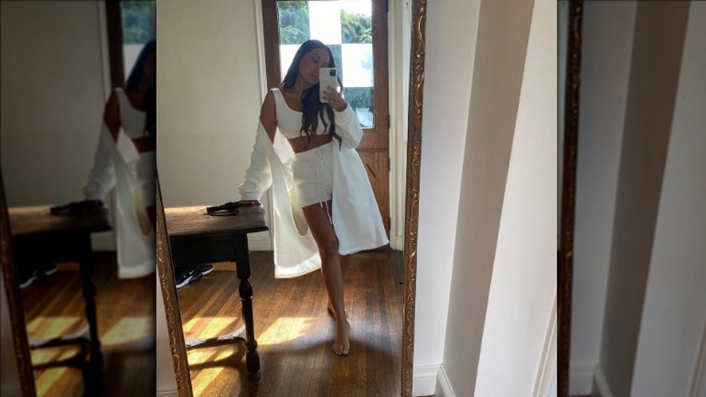 Adrienne Bailon in a full-length selfie