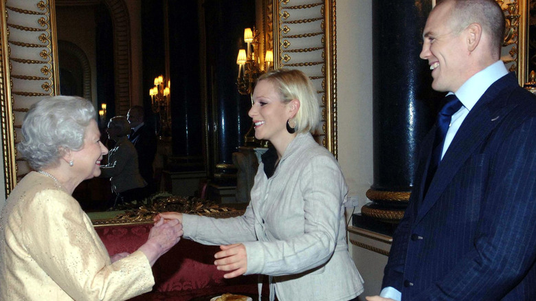 Queen Elizabeth II, Mike, and Zara Tindall smiling