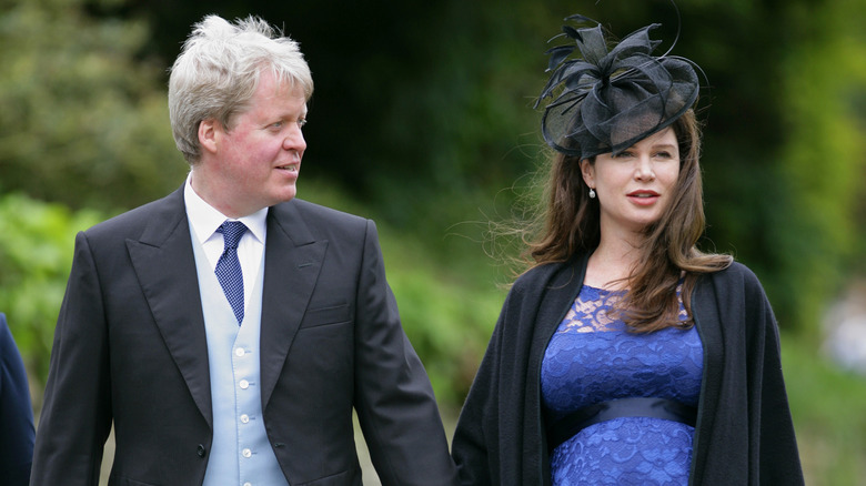 Charles Spencer smiles at his pregnant wife Karen Gordon as they attend Emily McCorquodale and James Hutt's wedding