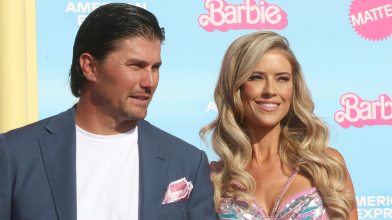 Joshua Hall and Christina Hall hold hands and converse at the Barbie World Premiere