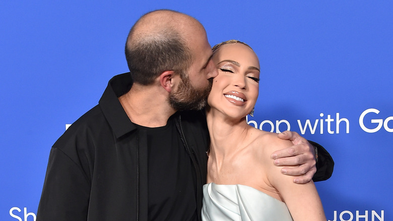 Christian Dumontet kisses Christine Quinn as they pose for a picture