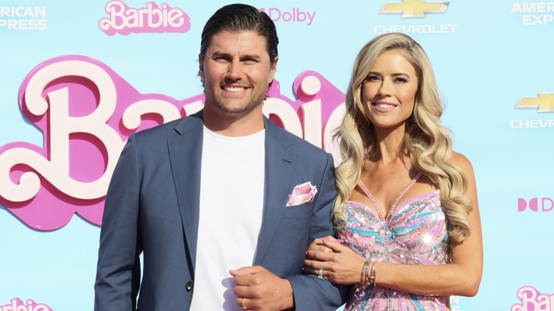 Josh Hall and Christina Hal arm-in-arm looking happy at the Barbie Premiere