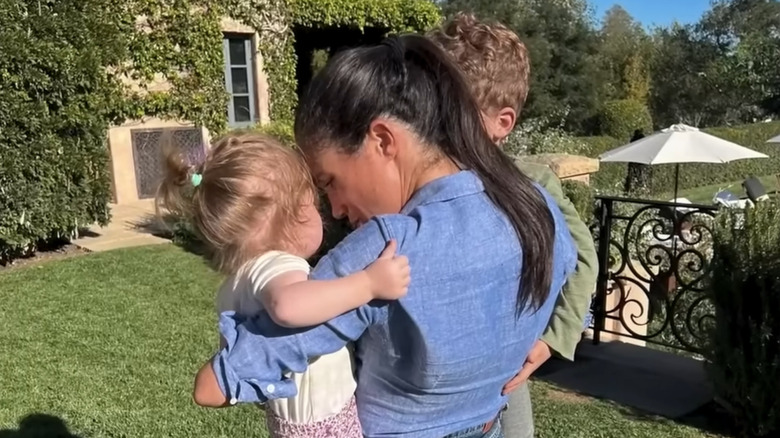 Meghan Markle holding Princess Lilibet and Prince Archie