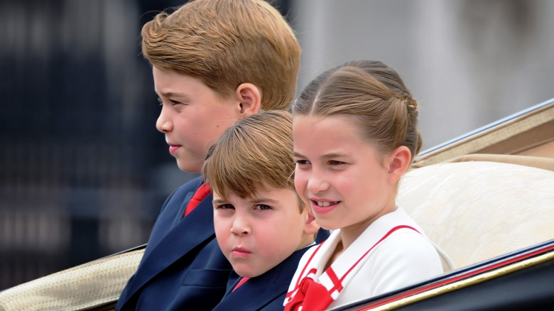 Prince George, Prince Louis, and Princess Charlotte riding in a carriage