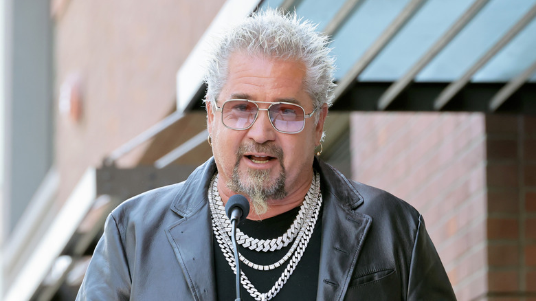 Guy Fieri speaking into a microphone