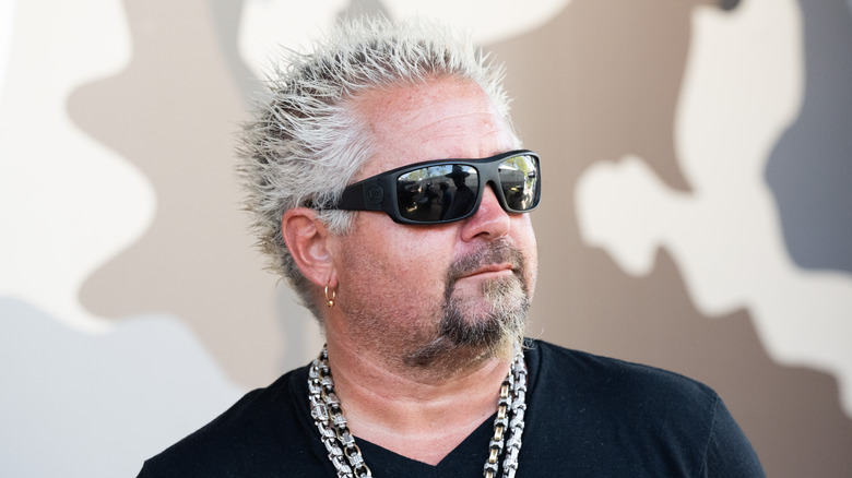 Guy Fieri looking off to the side