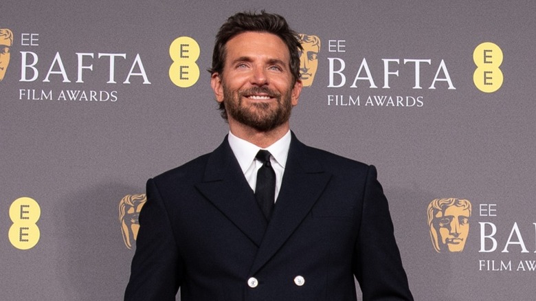 actor Bradley Cooper posing with a smile