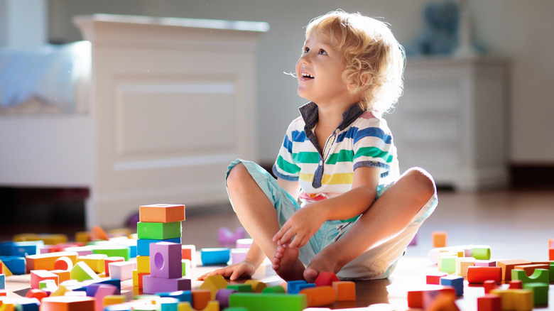 little boy playing with blocks 