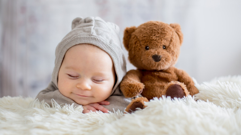 baby boy smiling with bear