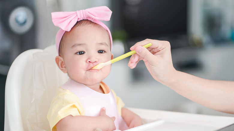 baby girl being fed