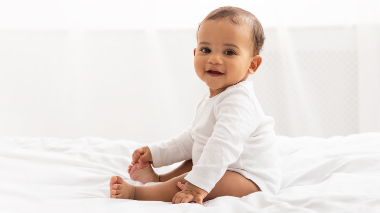 Baby in white outfit 