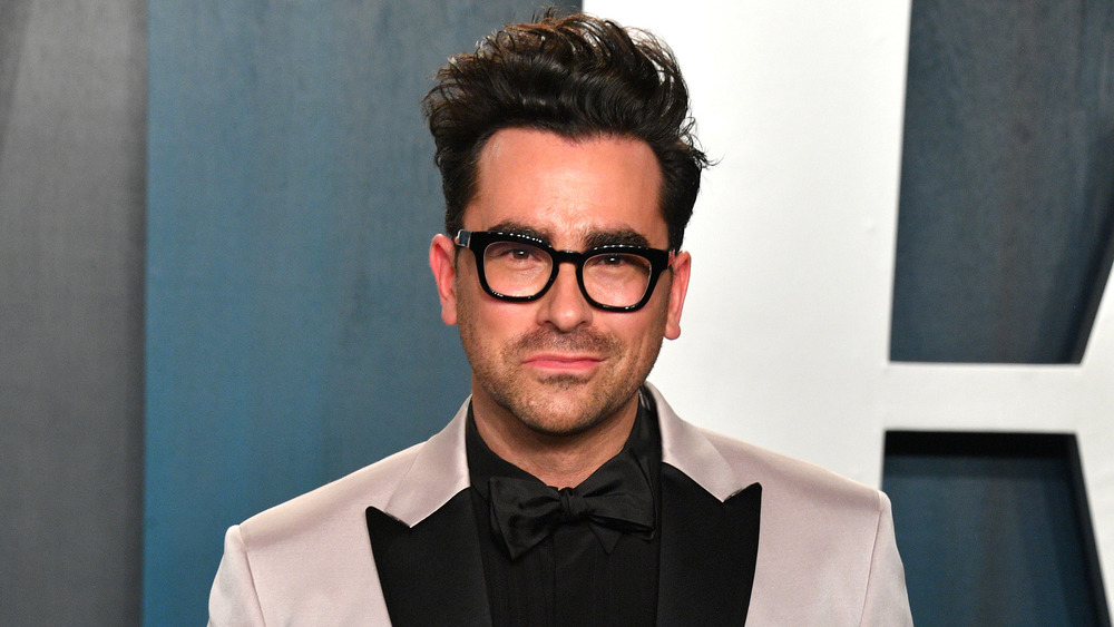 Dan Levy smiling on red carpet