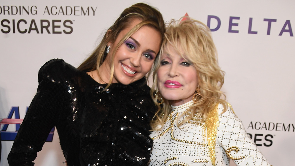 Miley Cyrus and Dolly Parton smiling