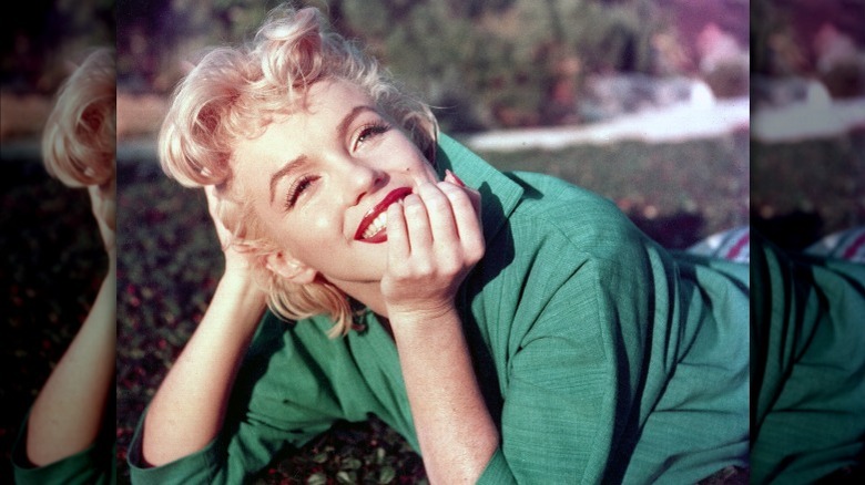 Marilyn Monroe stares up and poses for a photo